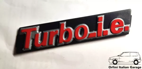 7577432 - Front Grill Badge Scritta - Fiat Uno Turbo IE View Front